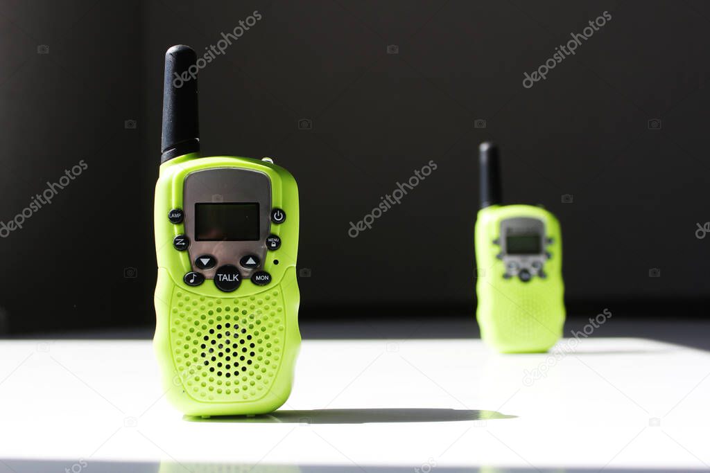 Two walkie talkies on a white table