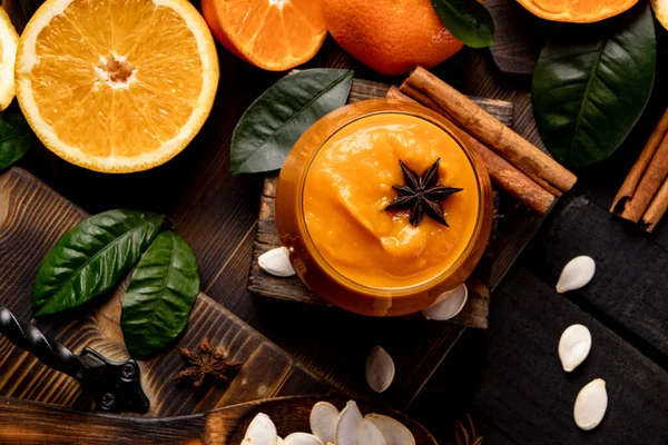 Glas Pompoen Sinaasappelsmoothies Met Specerijen Zwarte Houten Tafel Hoge Kwaliteit — Stockfoto