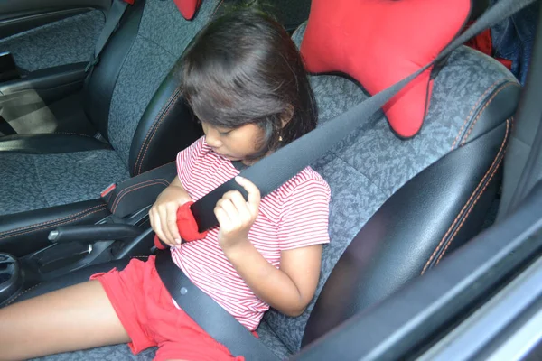 Little Girl Hold Seat Belt And Have Difficulty When Preparing Seat Belt Before Traveling