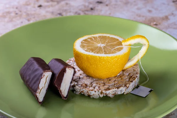 a mug of lemon with snacks. Photoilusion of tea with lemon. Unusual lemon tea with curd cheese.