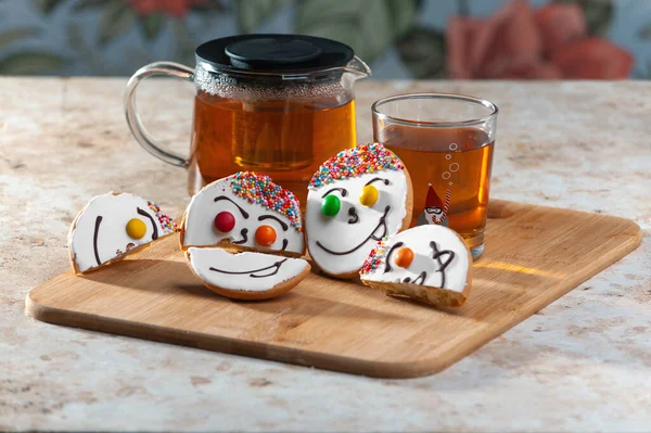 Holiday cookies and tea. Smiling cookies. Gingerbread man, tree and smiley. Gingerbread christmas party