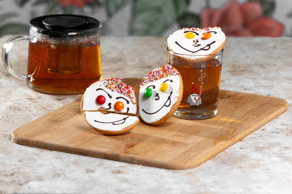 Holiday cookies and tea. Smiling cookies. Gingerbread man, tree and smiley. Gingerbread christmas party