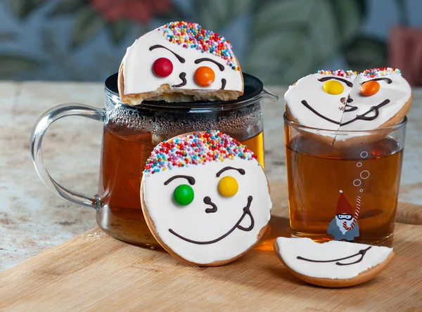 Holiday cookies and tea. Smiling cookies. Gingerbread man, tree and smiley. Gingerbread christmas party