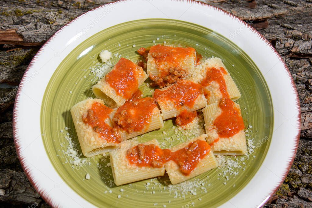 paccheri pasta with ragu and cacioricotta typical southern Italian cheese