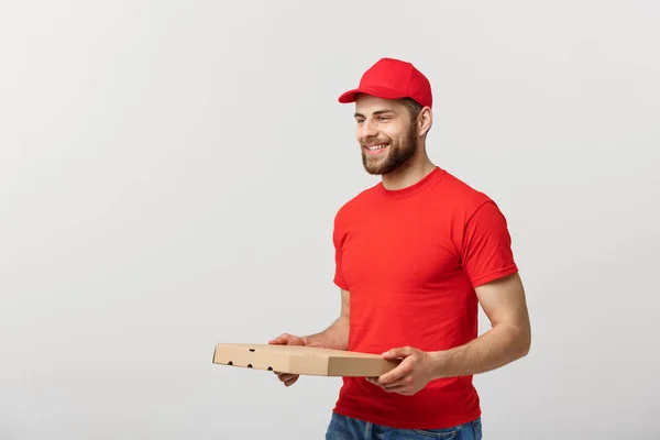 Concepto de entrega: Joven haapy caucásico guapo Pizza delivery man holding pizza boxes isolated over grey background —  Fotos de Stock