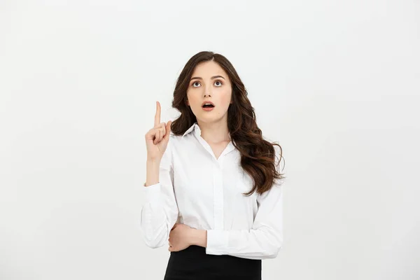 Business Concept: Attractive young Caucasian girl open her mouth and pointing her index finger to the top. She looks enthusiastic, isolated on white background — Stock Photo, Image