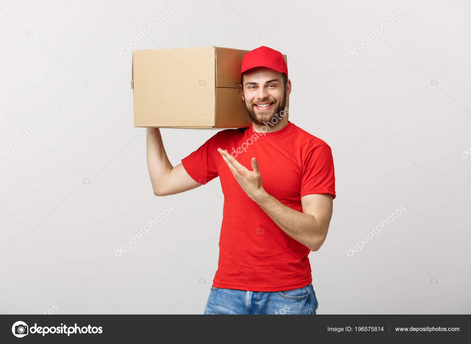 Delivery Concept Portrait Of Happy Caucasian Delivery Man Pointing Hand To Present A Box Package Isolated On Grey Studio Background Copy Space Stock Photo C Benzoix 196575814