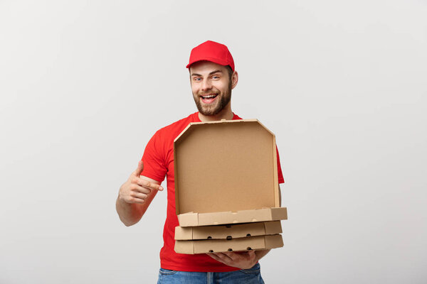 Pizza delivery concept. Young boy is delivering and showing pizza boxs in boxes. Isolated on white background