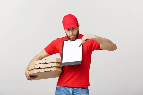 Delivery Concept: Young handsome delivery man with pizza boxes giving you a document to sign