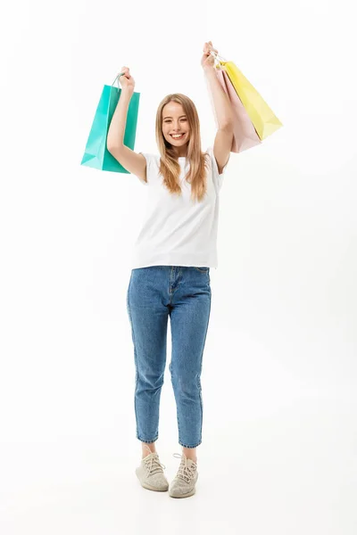 Volledige lengte portret van een mooie jonge vrouw poseren met boodschappentassen, geïsoleerd op witte achtergrond — Stockfoto