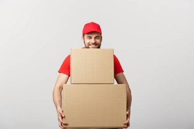 Delivery Concept: Man hardly carries the cardboard boxes, isolated on white background. Concept of difficult career of a delivery man clipart