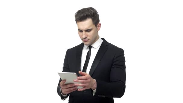 Young businessman working on tablet computer isolated on white background — Stock Video