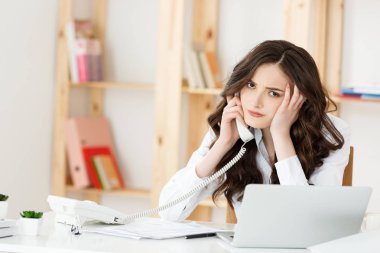 İş kavramı: Gülmeyen ve parlak modern ofis telefon ederek ciddi şirin işkadını