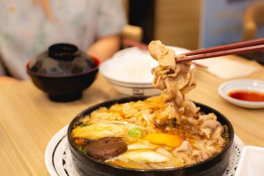 İki kişi domuz shabu veya güveç yemek yiyor. Aile zamanı.