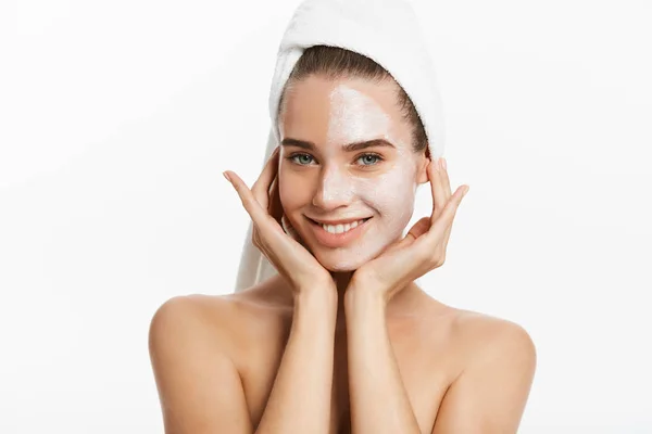 Young woman with clay facial mask, isolated on white — Stock Photo, Image