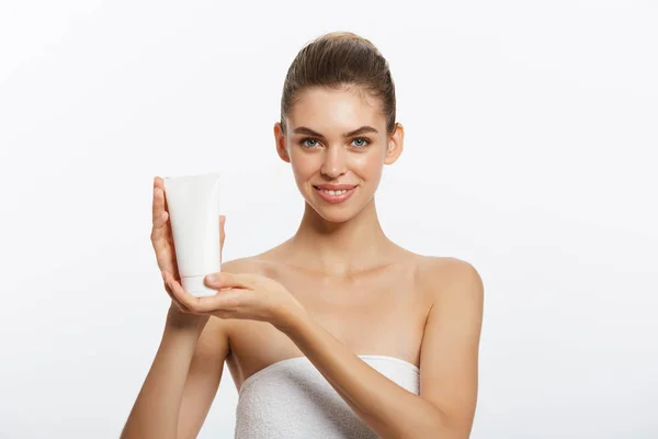 Beauty Youth Skin Care Concept - Linda Mulher Caucasiana Face Portrait segurando e apresentando produto de tubo de creme. Linda modelo de Spa Menina . — Fotografia de Stock