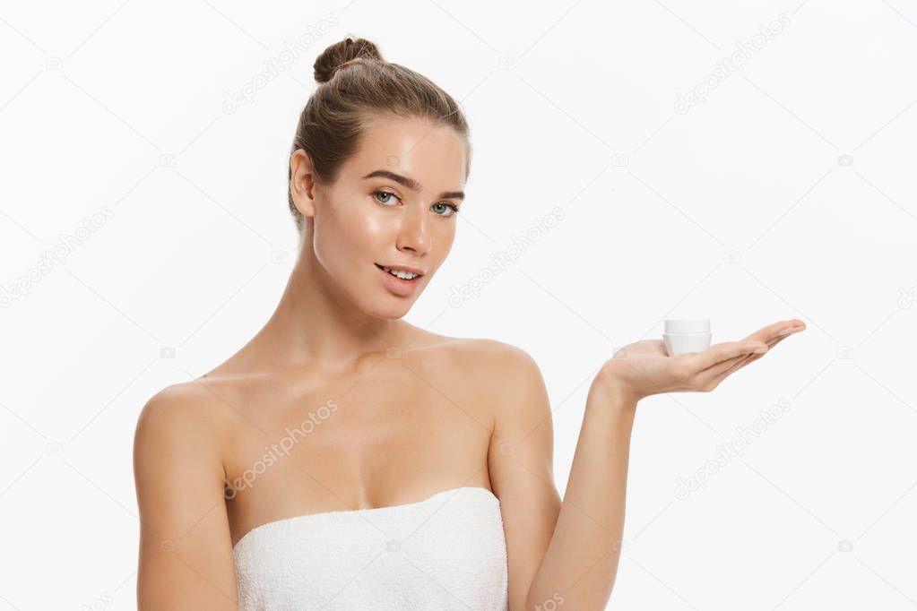 Beauty Youth Skin Care Concept - Beautiful Caucasian Woman Face Portrait holding and presenting cream tube product. Beautiful Spa model Girl with Perfect Fresh Clean Skin over white background