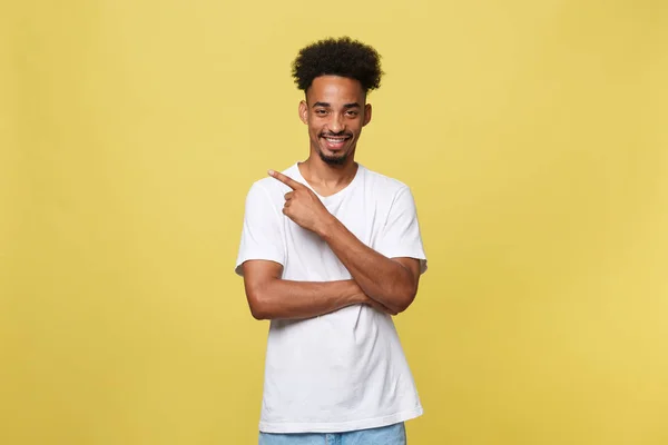 Young handsome african american man over yellow background pointing upwards. — Stock Photo, Image