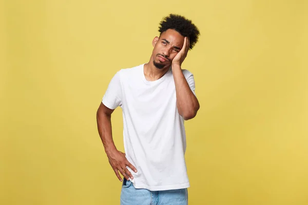 Unhappy dark-skinned male student squeezing head with hands, writhing in pain, suffering from headache after he spent sleepless night preparing for exams. People, stress, tension and migraine — Stock Photo, Image