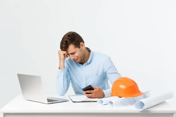 Serious man businessman or engineer sitting in construction site. Courageous middle aged man sit with sad,serious and depressed facial expression.