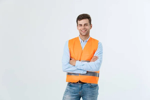 Glad ingenjör leende och ständiga tryggt, killen bär caro skjorta och jeans med orange väst, isolerad på vit bakgrund. — Stockfoto