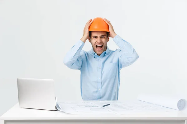 Young Engineer angry during working with laptop in office building site, he has problems with his new project manager — Stock Photo, Image