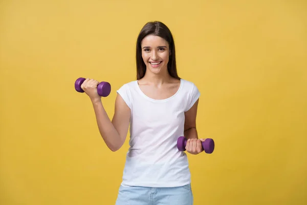 Shot Beautiful Sporty Young Woman Lifting Weights Yellow Background — Stock Photo, Image