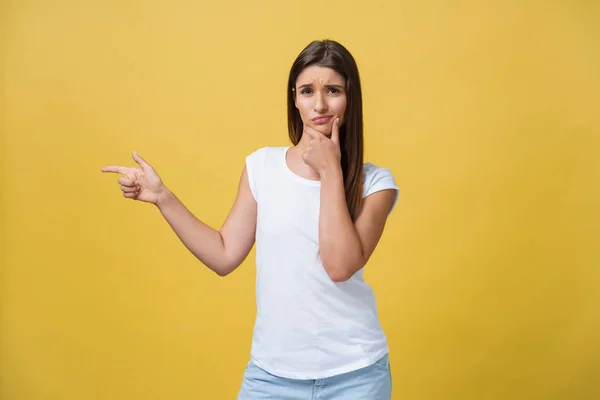 Closeup portrait of young pretty unhappy, serious woman pointing at someone as if to say you did something wrong, bad mistake isolated on yellow background. Negative emotion, facial expression feeling — Stock Photo, Image