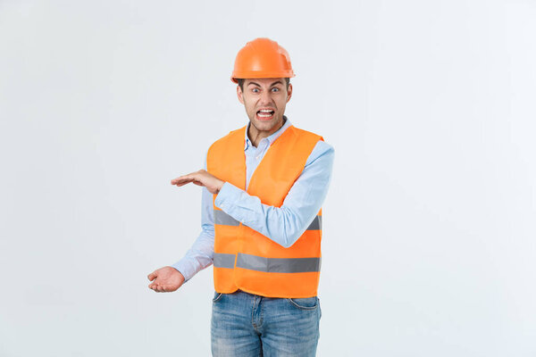 Happy beard engineer holding hand on side and explaining something, guy wearing caro shirt and jeans with yellow vest and orange helmet, isolated on white background