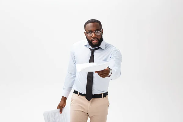 Business Concept - Young angry African American businessman while eating balled report paper. Unsuccessful Project. — Stock Photo, Image