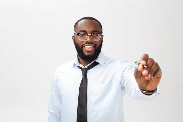 Young African american business man writing something on glass board with a marker