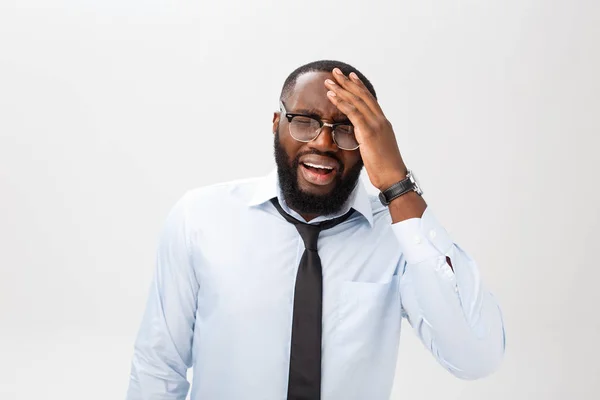 Portrait of desperate annoyed black male screaming in rage and anger tearing his hair out while feeling furious and mad with something. Negative human face expressions, emotions and feelings.