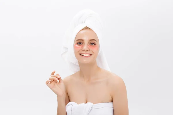 Close-up of a young woman with patches under eyes from wrinkles and dark circles. Isolated on white background — Stock Photo, Image