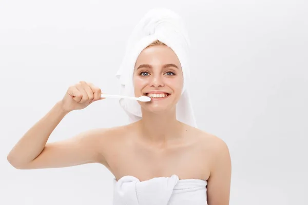 Portrait of attractive caucasian smiling woman isolated on white studio shot head and shoulders face skin hand with tooth brush — Stock Photo, Image