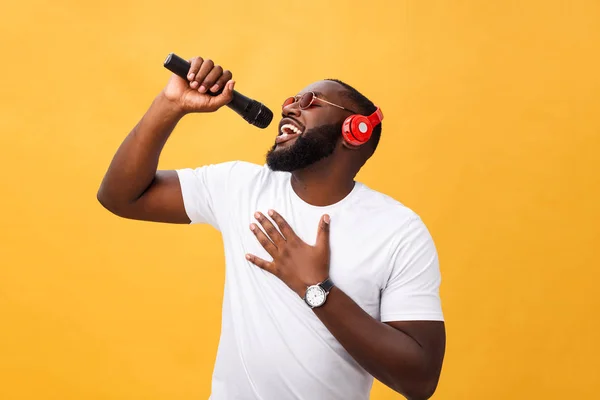 Young handsome african american boy singing emotional with micro — Stock Photo, Image
