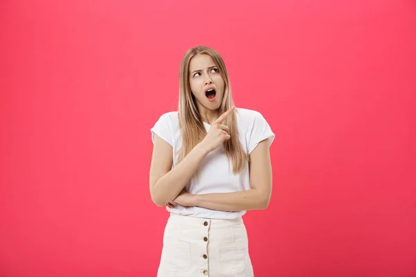 Surprised teenage student girl show shocking expression with something. Isolated on Bright Pink Background. Copy space — Stock Photo, Image