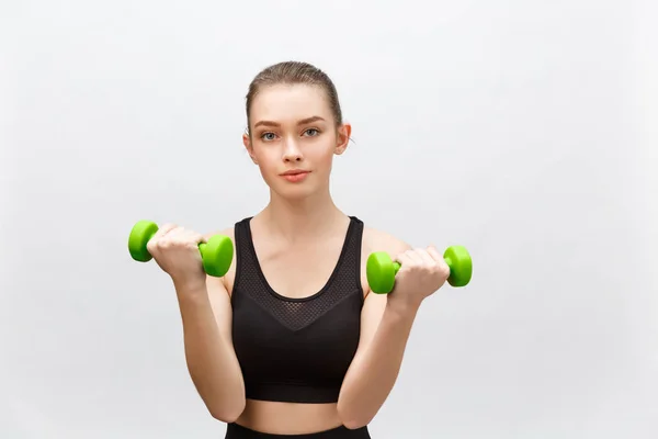 Happy fitness woman lifting dumbbells smiling cheerful, fresh and energetic. Caucasian fitness girl training isolated on white background. — Stock Photo, Image