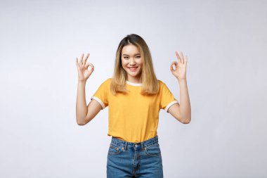 Asyalı Genç kadın güzel gülümseme ile ok parmak işareti beyaz arka plan üzerinde izole