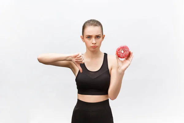 Beautiful young woman over grey background eating donut stressed with hand on head, shocked with shame and surprise face, angry and frustrated. Fear and upset for mistake — Stock Photo, Image