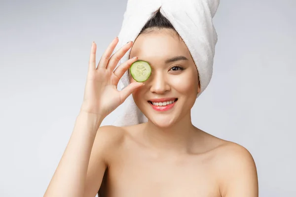 stock image Beauty young asian women skin care image with cucumber on white background studio.