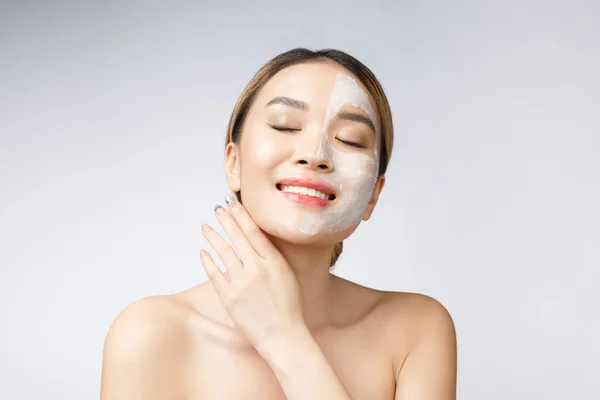 Charming pleasant woman applying cream on half face. — Stock Photo, Image