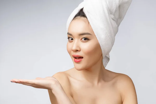 Retrato hermosa mujer asiática wow sorprendido y señalando la mano hacia el lado derecho sobre fondo gris, emociones acción, mostrando su producto o mensaje — Foto de Stock