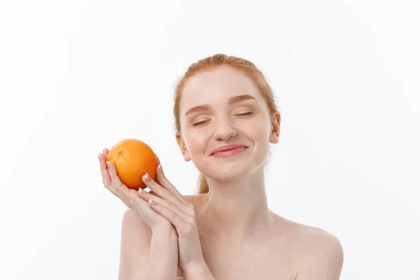 Portrait beautiful woman with a orange isolated. — Stock Photo, Image