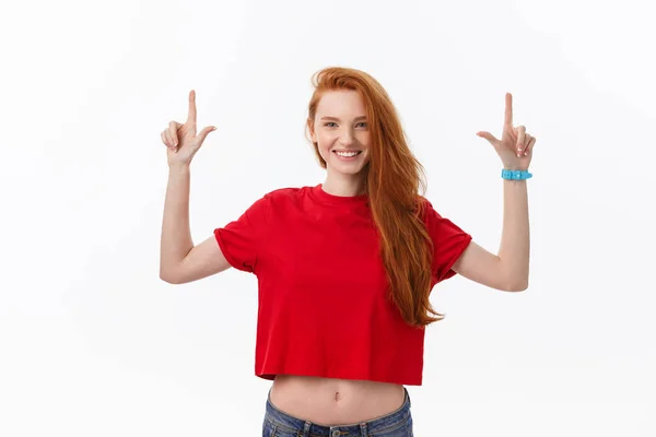 Photo of happy young woman standing isolated over white wall background. Looking camera showing copyspace pointing — Stock Photo, Image