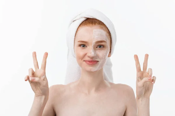 Beautiful caucasian woman applying mask on her face with two fingers sign white background. — Stock Photo, Image