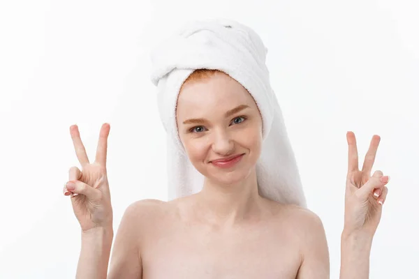 Beautiful caucasian woman applying mask on her face with two fingers sign white background. — Stock Photo, Image