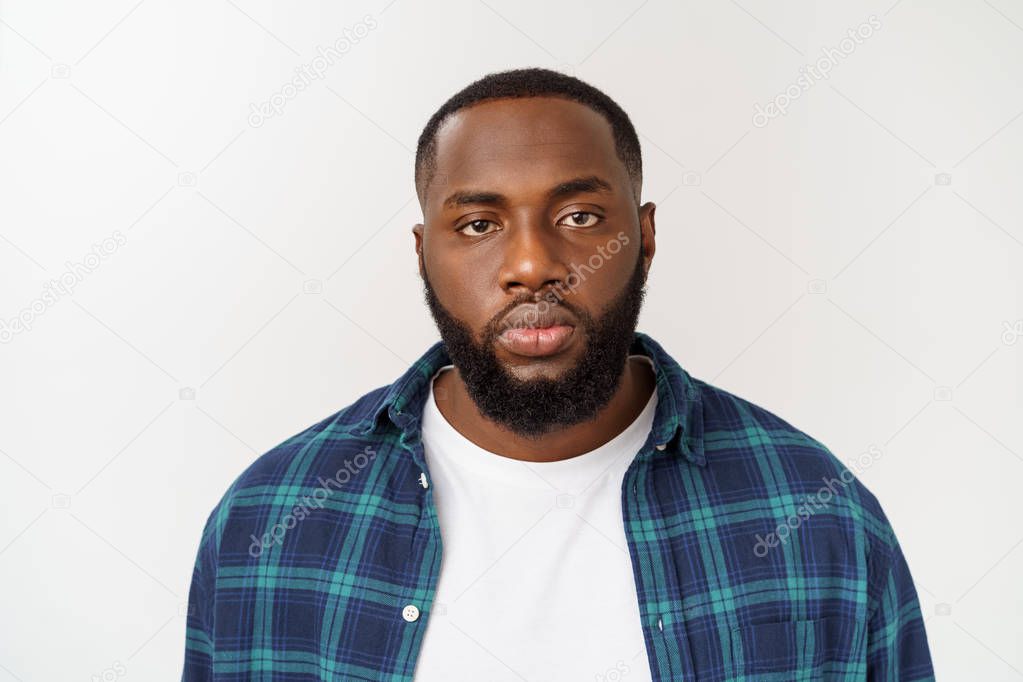 Head shot of an angry African-american man looking sharply towards the camera.