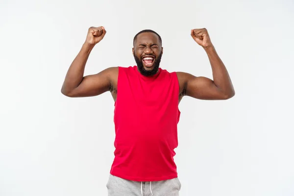 stock image Young fitness african black man in sport wear cheering carefree and excited. Victory concept.