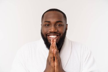 Sakin, yakışıklı Afrikalı adam dua ediyor. El ele tutuşup meditasyon yapan ciddi, barışçıl genç bir adam. İnanç kavramı