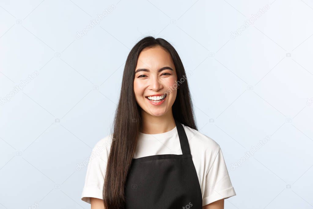 Coffee shop, small business and startup concept. Carefree smiling, cheerful asian female smiling and laughing, upbeat atmosphere at cafe, serving coffee to clients, white background